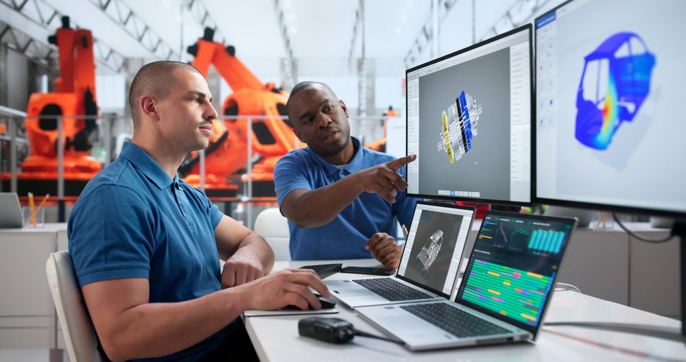 Engineers reviewing electric-machine geometry and simulation results